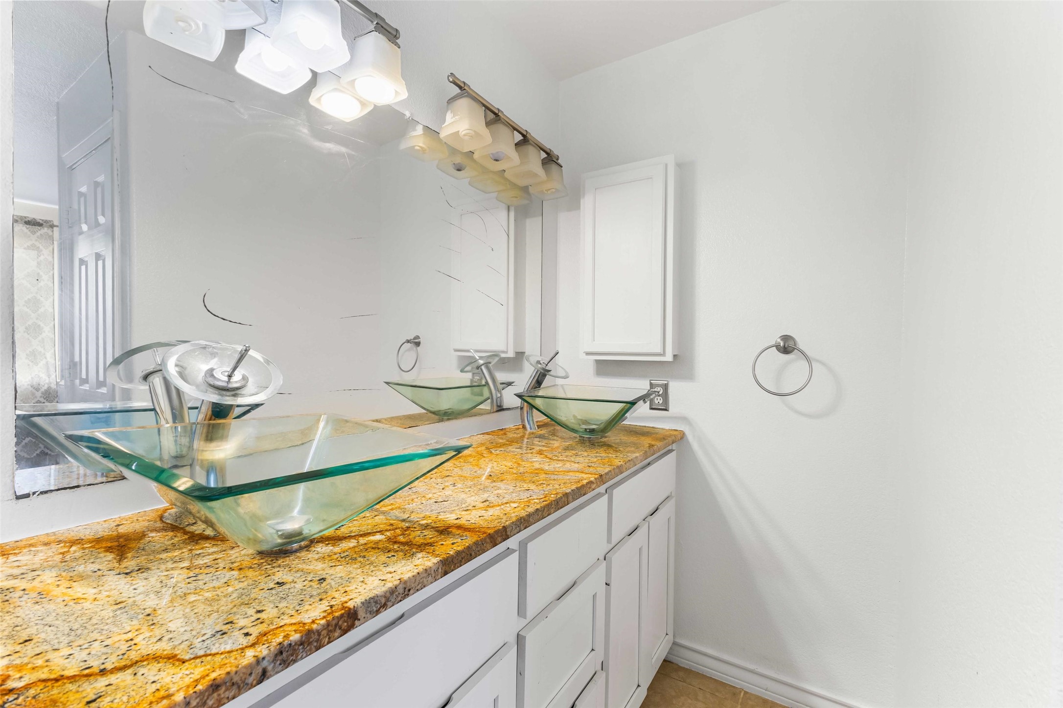 12212 Ballerstedt Road Elgin, TX 78621 - Photo 18 of 39 a bathroom with a granite countertop sink and a mirror