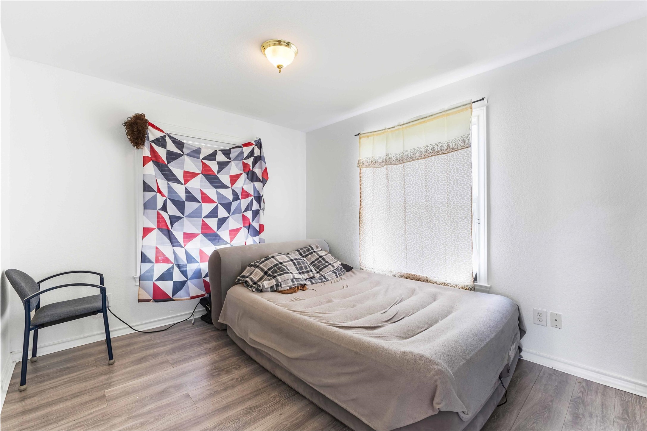 12212 Ballerstedt Road Elgin, TX 78621 - Photo 23 of 39 a bedroom with a bed and a dresser
