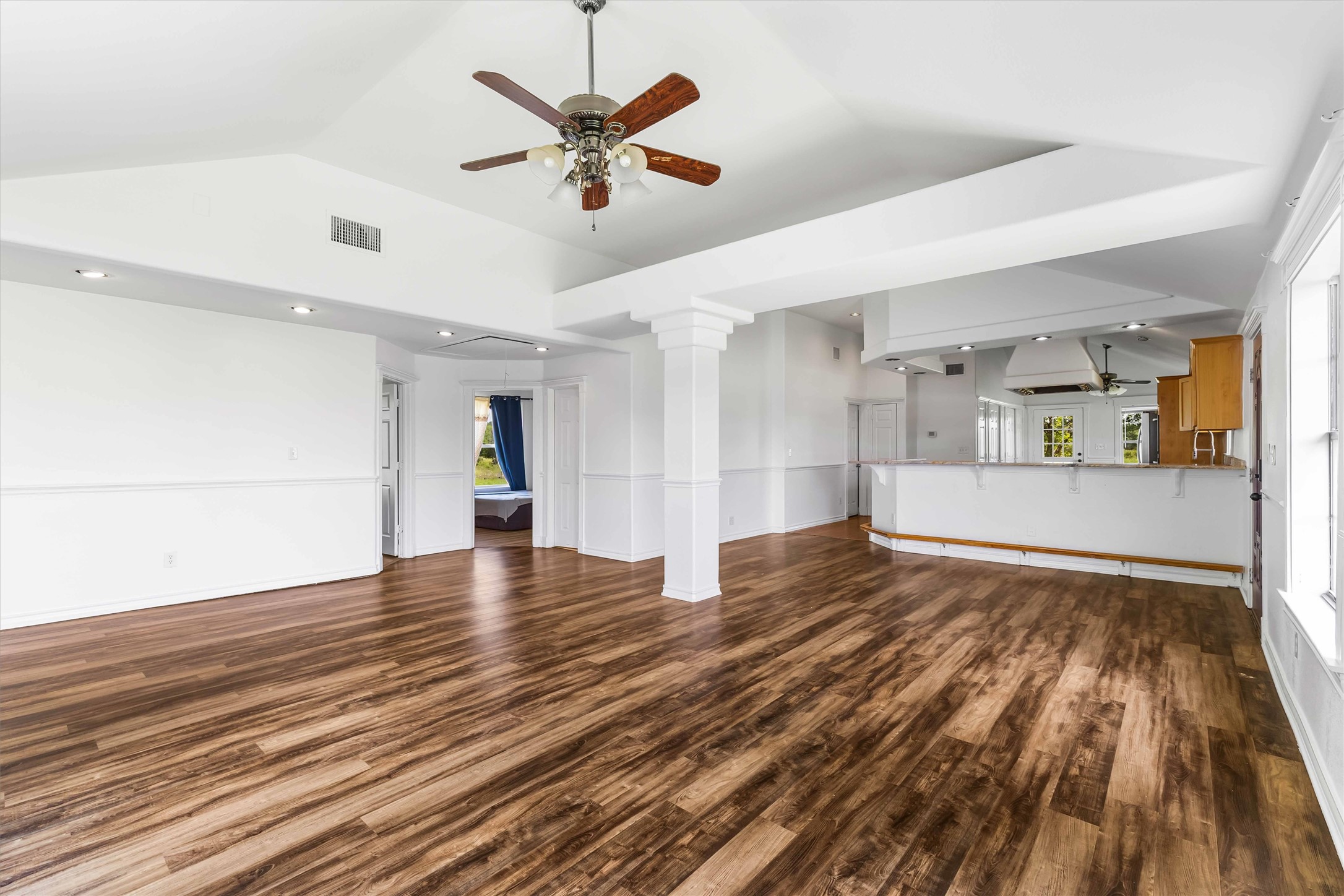 12212 Ballerstedt Road Elgin, TX 78621 - Photo 7 of 39 a view of a livingroom with wooden floor and a ceiling fan