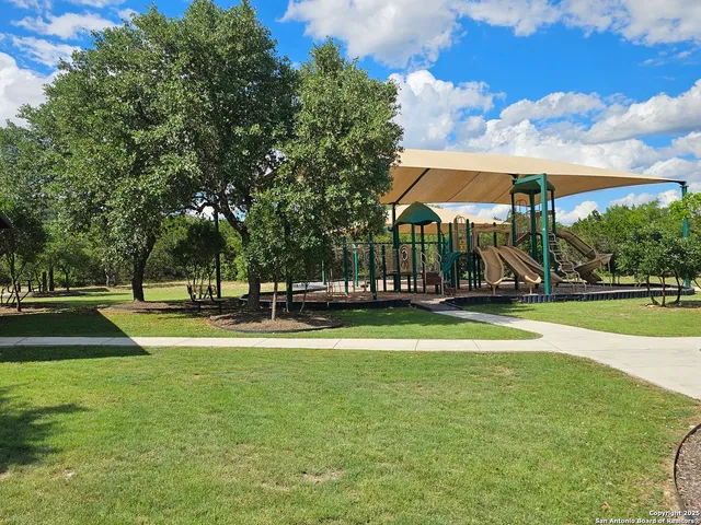 a view of yard with swimming pool and trees