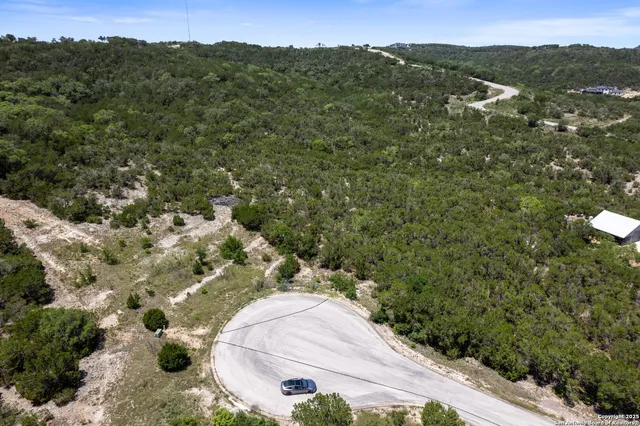 an aerial view of a house with a yard