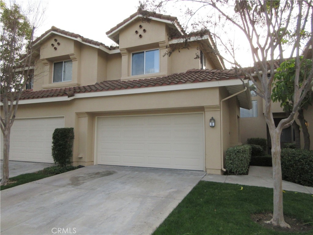 6 Codoniz Rancho Santa Margarita, CA 92688 - Photo 1 of 1 a front view of a house with a yard and garage