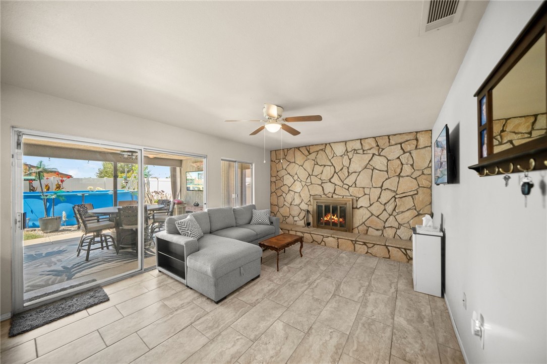 27879 Foxfire Street Menifee, CA 92586 - Photo 17 of 36 a living room with furniture and a flat screen tv