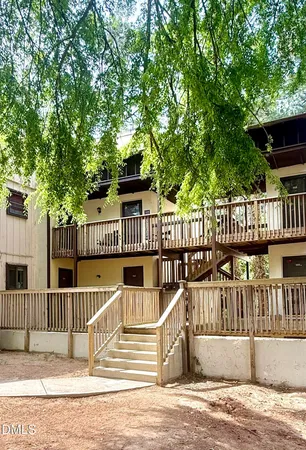 a view of a house with backyard and deck
