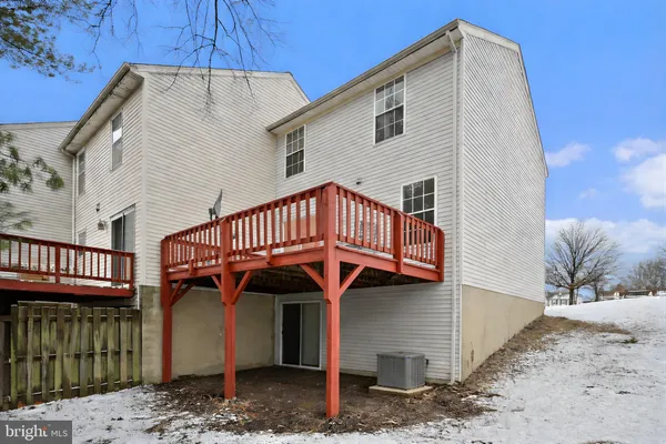 a view of a brick house with a yard and large tree
