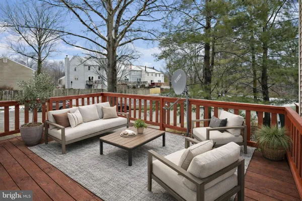 a view of a roof deck with couches and wooden floor