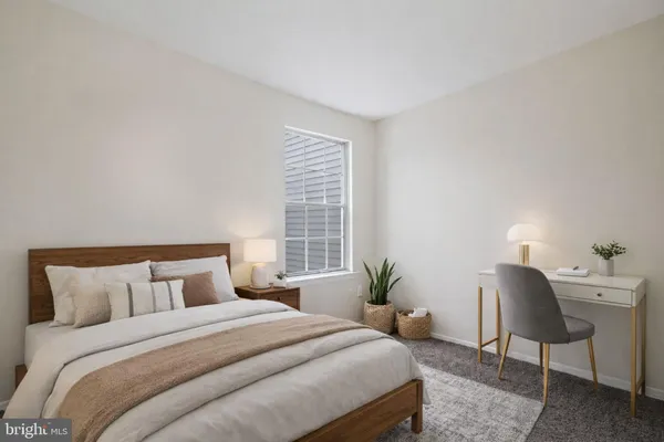 a bedroom with a bed a table and chair