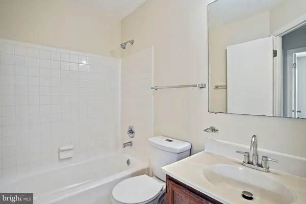 a bathroom with a sink toilet tub and shower
