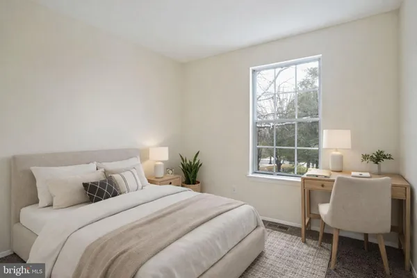 a bedroom with a bed and a table in it