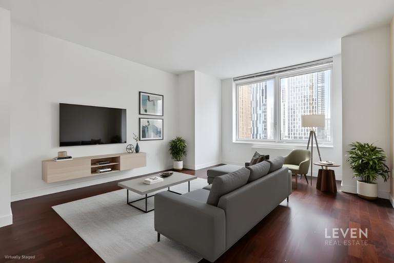 306 Gold Street, Unit 16D Brooklyn, NY 11201 - Photo 1 of 15 a living room with furniture and a flat screen tv
