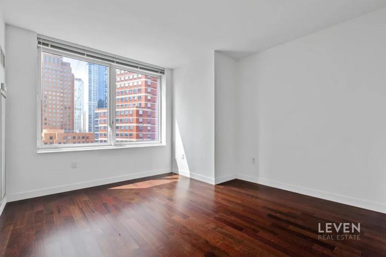 306 Gold Street, Unit 16D Brooklyn, NY 11201 - Photo 5 of 15 a view of a room with wooden floor and a window