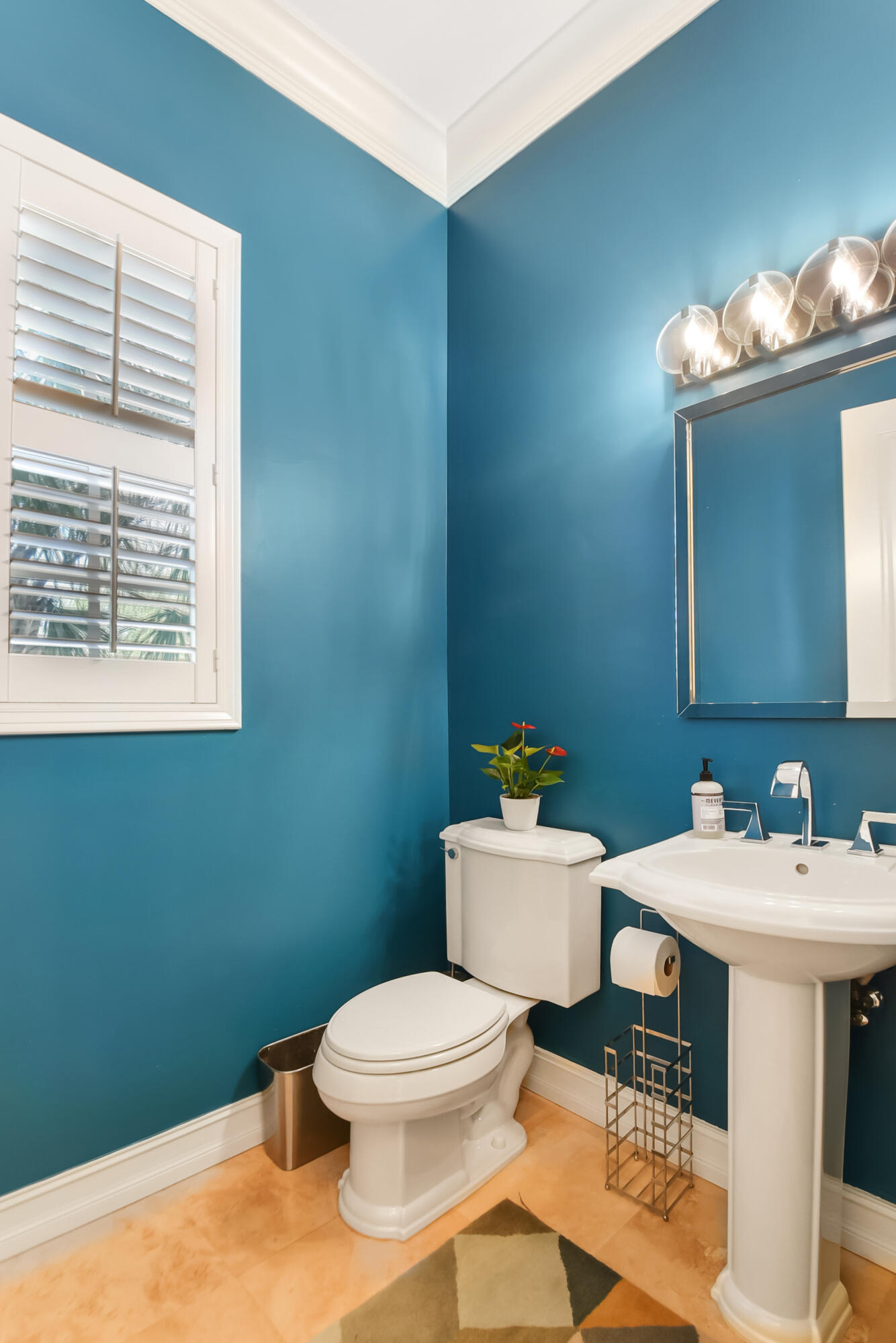 609 Renaissance Way Delray Beach, FL 33483 - Photo 9 of 22 a bathroom with a sink a toilet and mirror