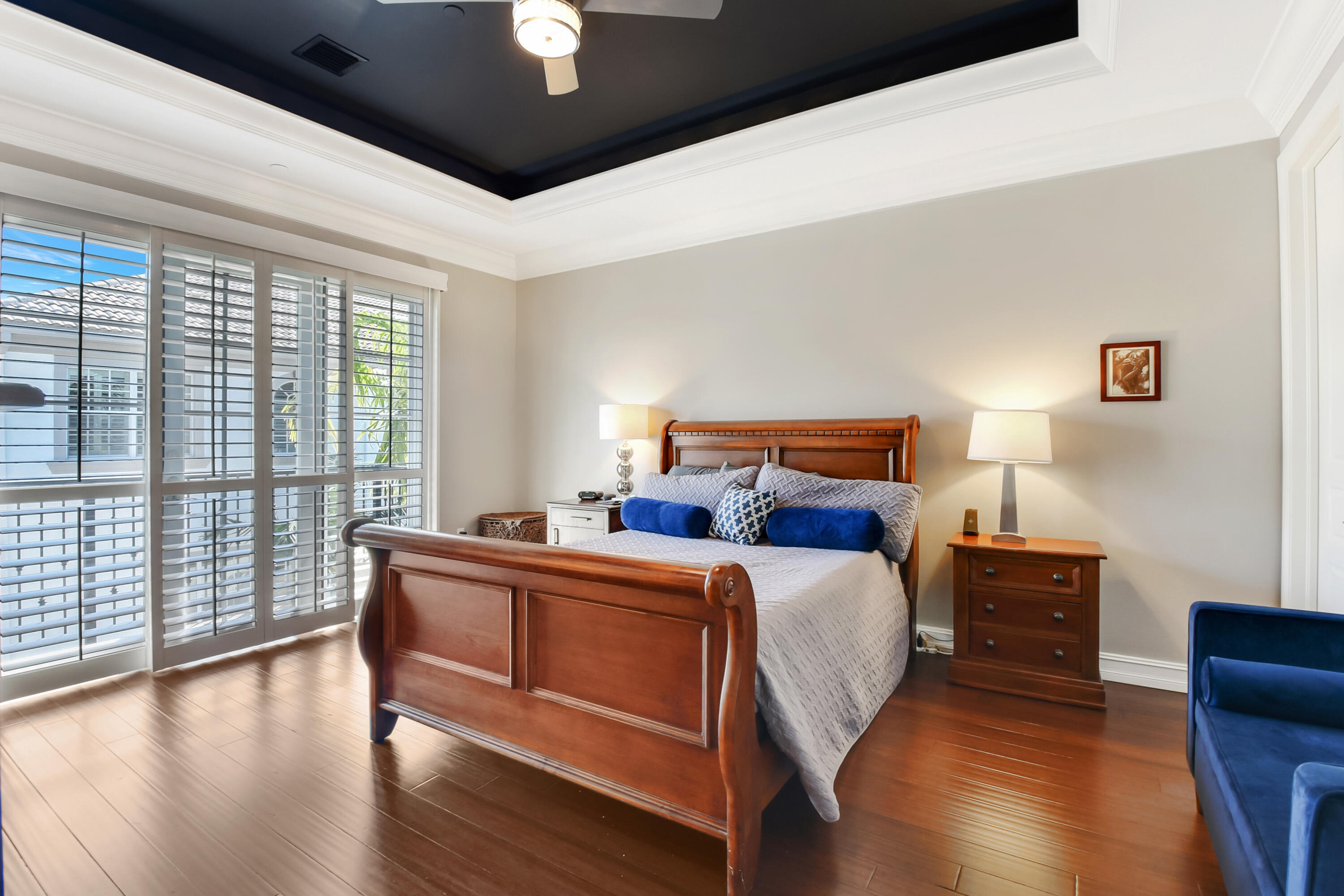 609 Renaissance Way Delray Beach, FL 33483 - Photo 10 of 22 a bedroom with a bed and wooden floor