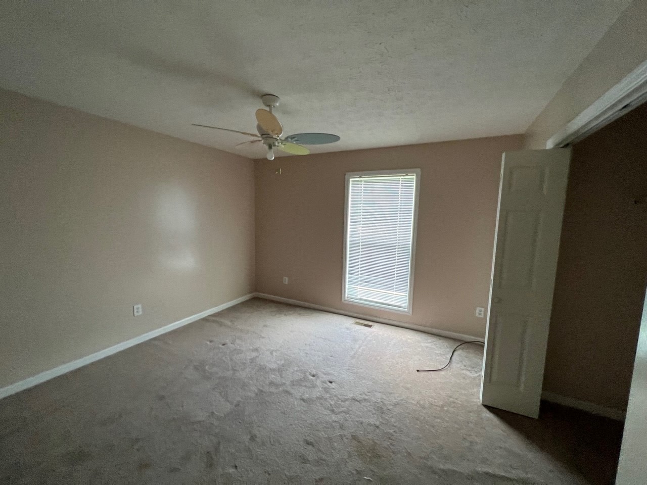 1058 Halls Mill Road Unionville, TN 37180 - Photo 19 of 32 an empty room with a ceiling fan and a window