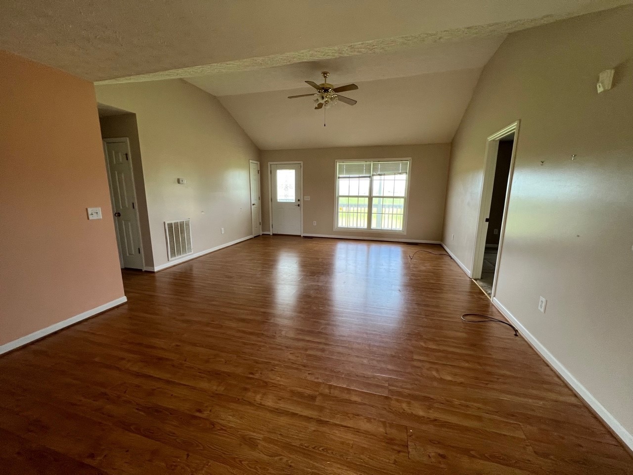 1058 Halls Mill Road Unionville, TN 37180 - Photo 27 of 32 an empty room with wooden floor fan and windows