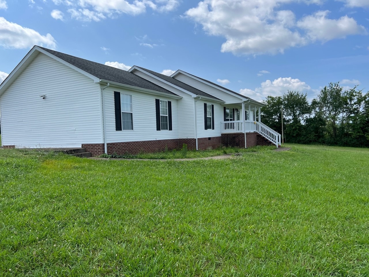 1058 Halls Mill Road Unionville, TN 37180 - Photo 32 of 32 a house with green field in front of it