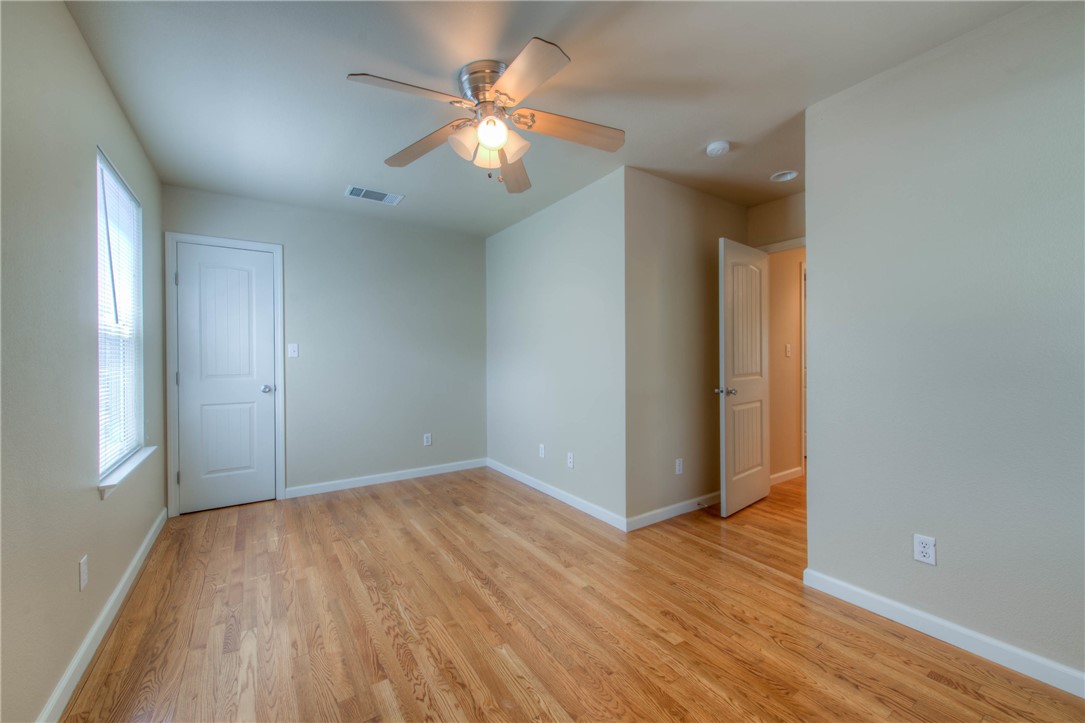4805 Evans Avenue, Unit B Austin, TX 78751 - Photo 17 of 25 an empty room with wooden floor and windows