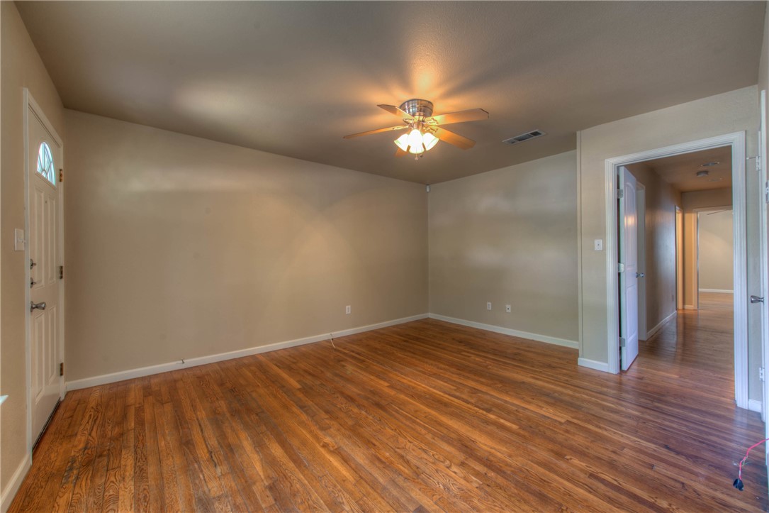 4805 Evans Avenue, Unit B Austin, TX 78751 - Photo 5 of 25 an empty room with wooden floor chandelier fan and closet area