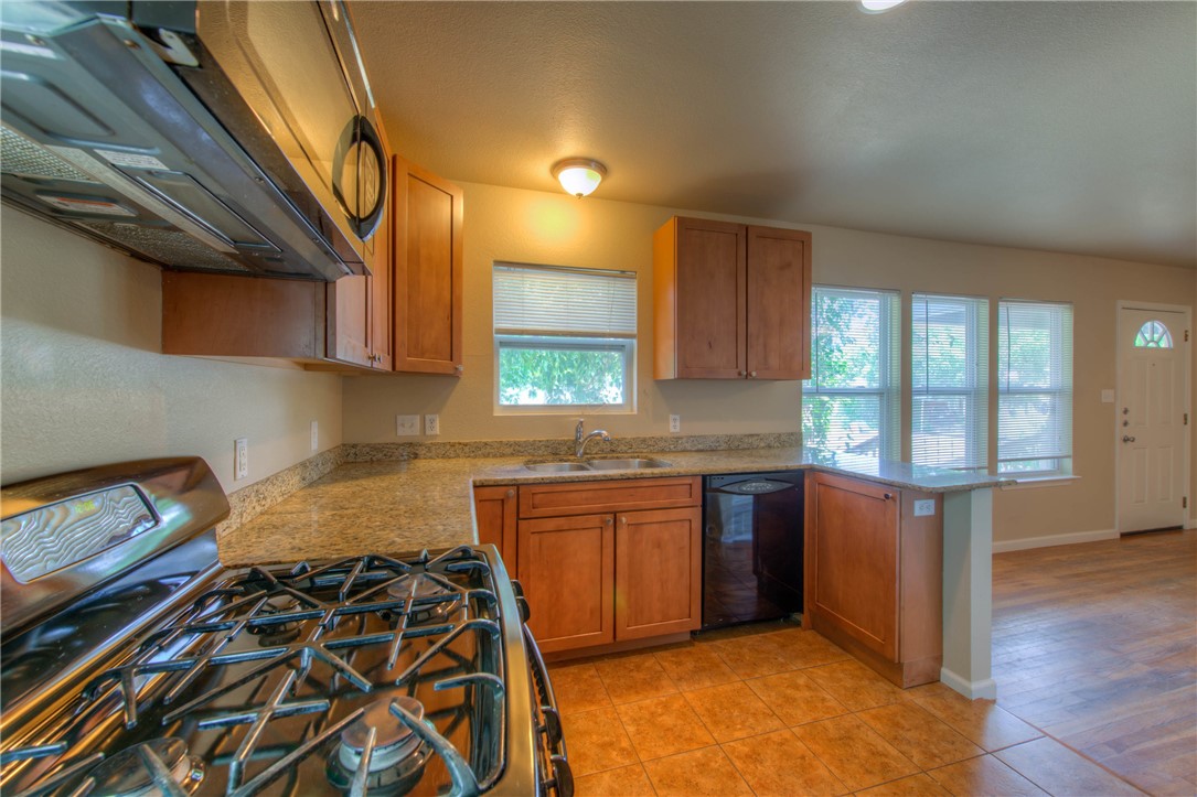 4805 Evans Avenue, Unit B Austin, TX 78751 - Photo 8 of 25 a kitchen with a stove a sink and a microwave
