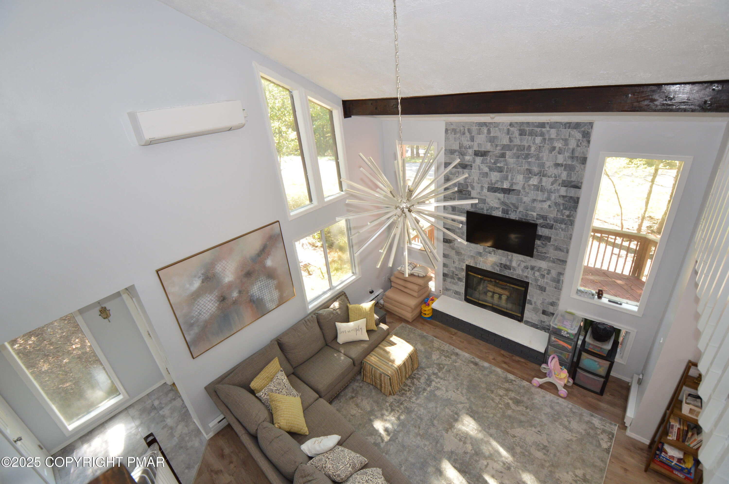 128 Ashley Court Bushkill, PA 18324 - Photo 33 of 43 a living room with furniture a flat screen tv and a fireplace