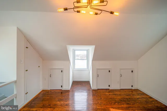 a view of a room with wooden floor