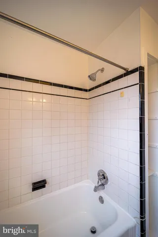 a bathroom with a shower and a sink