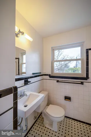 a bathroom with a sink toilet and mirror