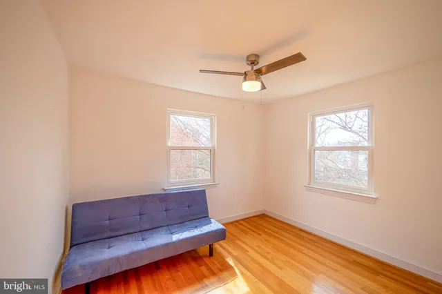 a view of room with window and wooden floor