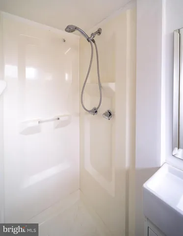 a bathroom with a glass shower door