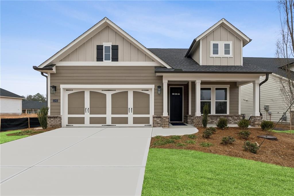 1041 Pine Bark Lane Canton, GA 30114 - Photo 1 of 19 a front view of a house with a yard and seating space