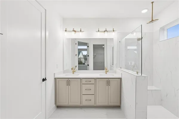 a bathroom with a sink double vanity and a mirror