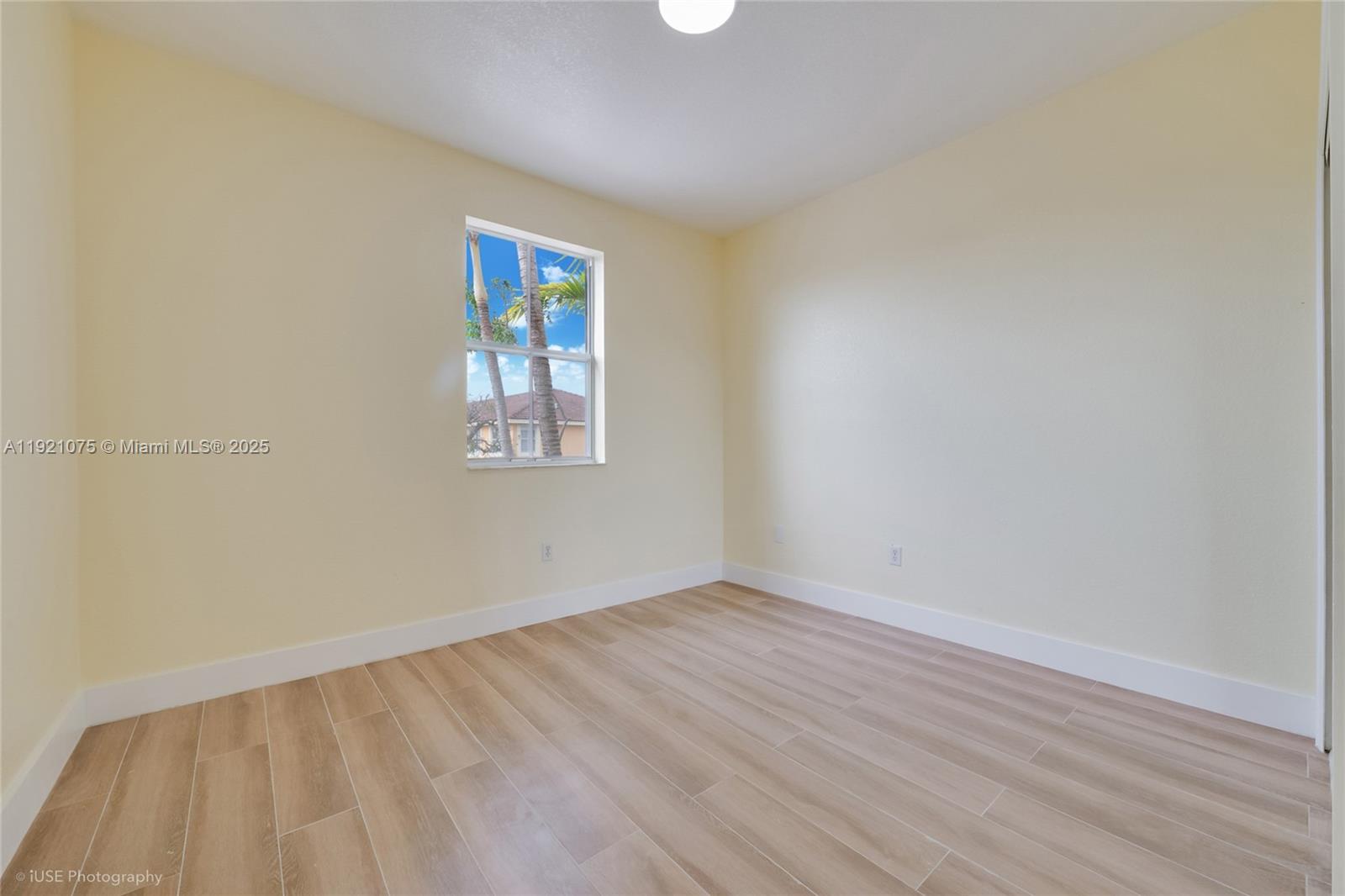 24331 Southwest 108th Place Homestead, FL 33032 - Photo 11 of 15 wooden floor in an empty room with a window