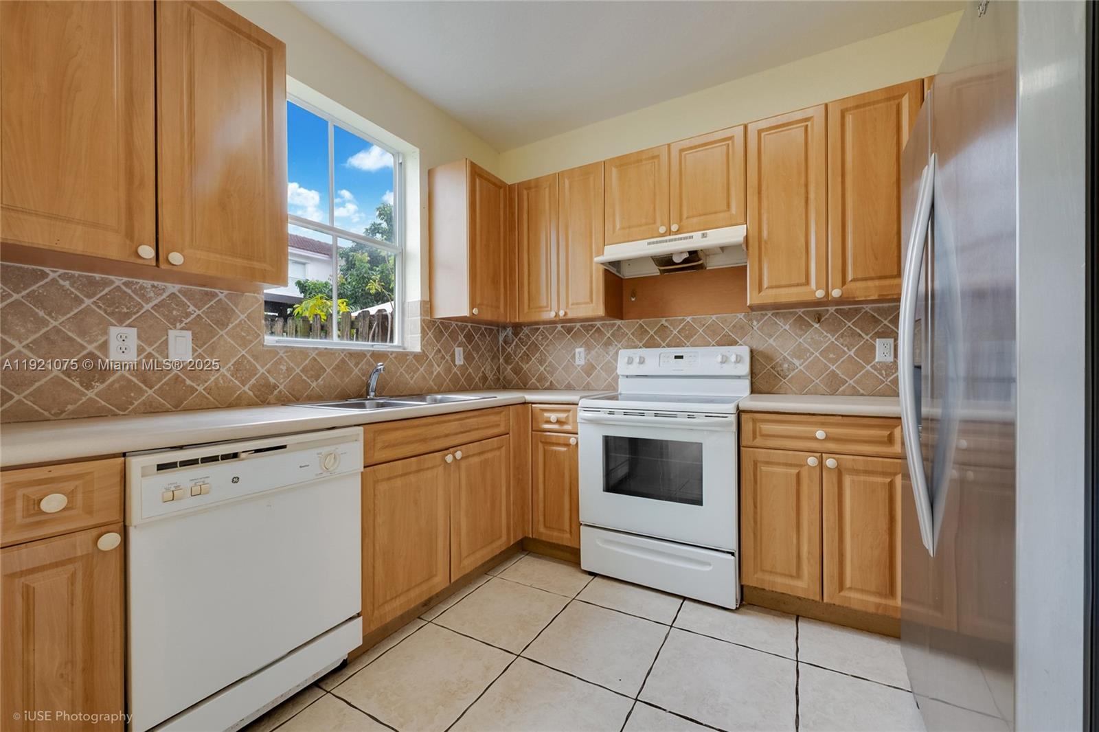 24331 Southwest 108th Place Homestead, FL 33032 - Photo 6 of 15 a kitchen with a stove sink and cabinets