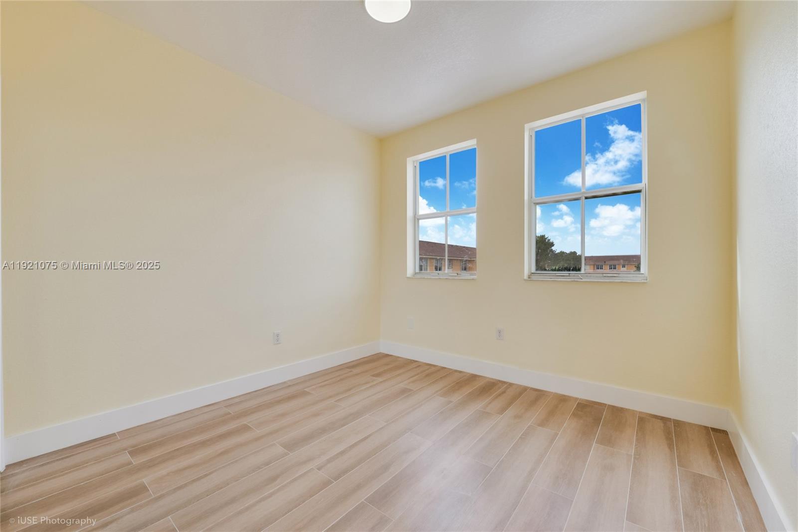 24331 Southwest 108th Place Homestead, FL 33032 - Photo 7 of 15 a view of an empty room with wooden floor and a window