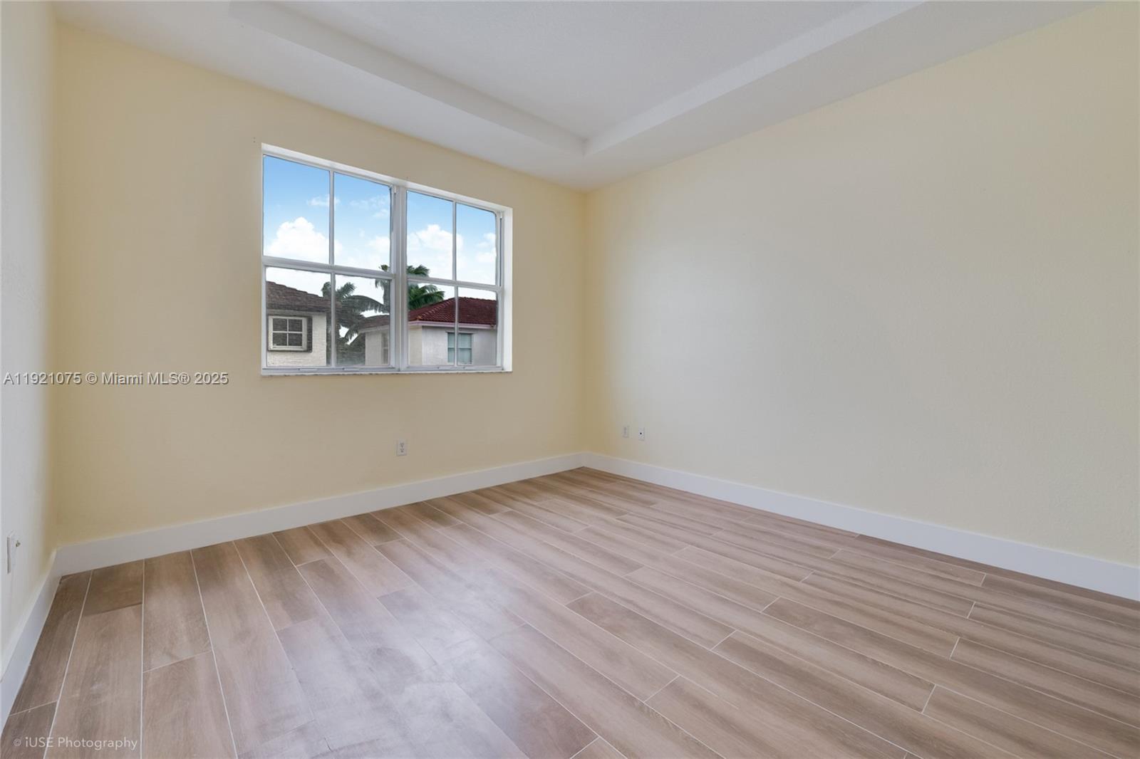 24331 Southwest 108th Place Homestead, FL 33032 - Photo 9 of 15 an empty room with wooden floor and windows