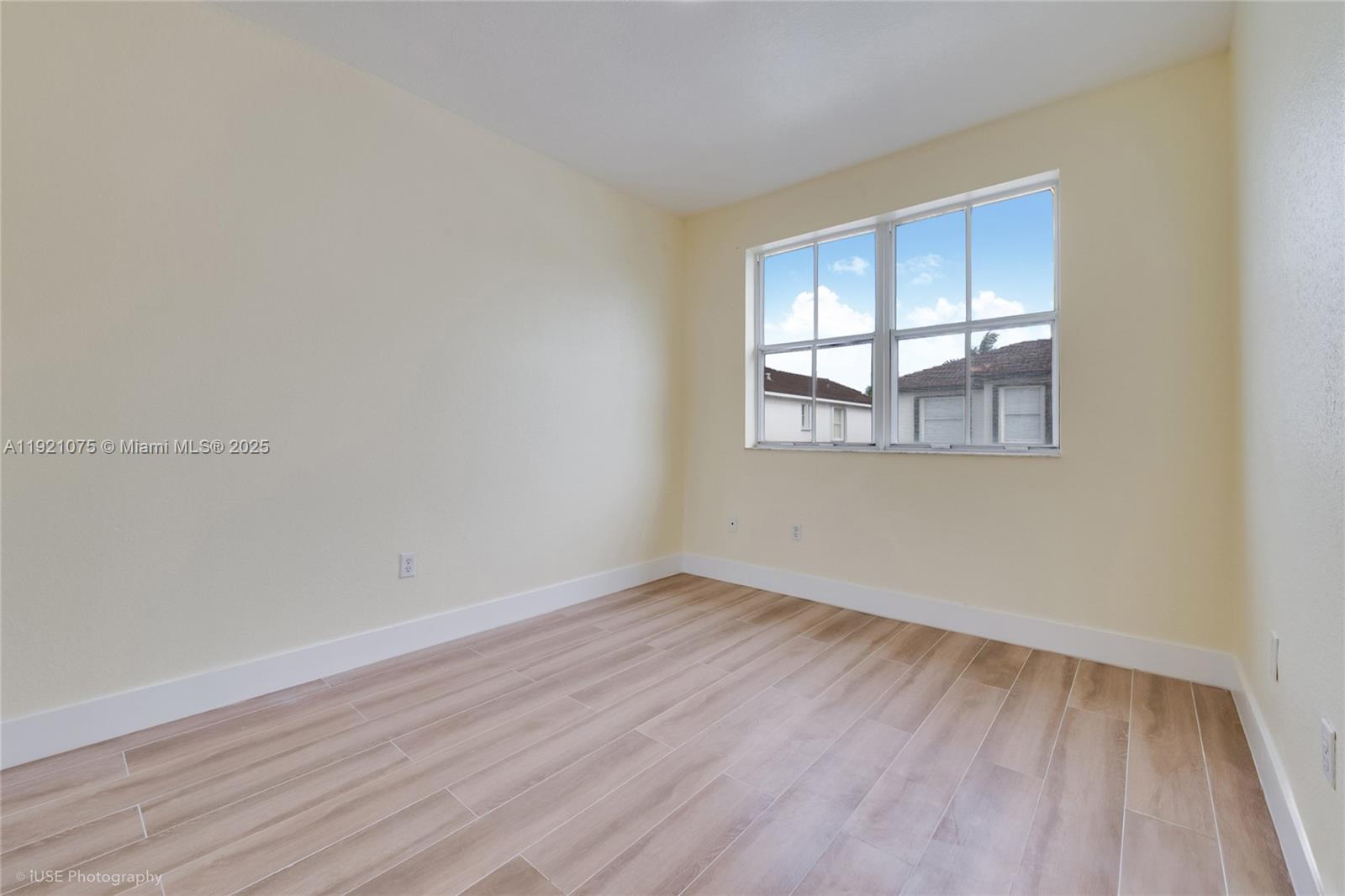 24331 Southwest 108th Place Homestead, FL 33032 - Photo 10 of 15 an empty room with wooden floor and windows