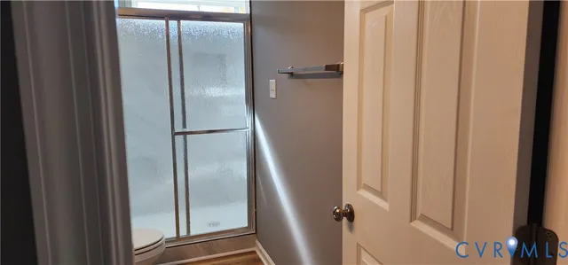 a bathroom with a glass shower door
