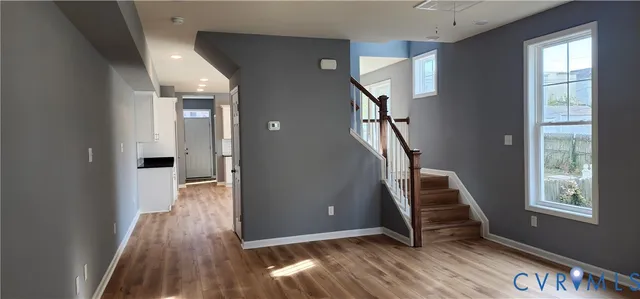 a view of entryway with wooden floor and stairs