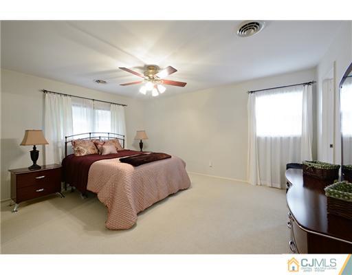 10 Midland Road Edison, NJ 08820 - Photo 12 of 18 a spacious bedroom with a bed and a chandelier