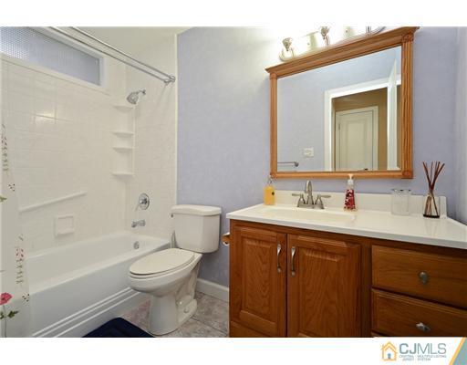 10 Midland Road Edison, NJ 08820 - Photo 15 of 18 a bathroom with a sink toilet a mirror and shower