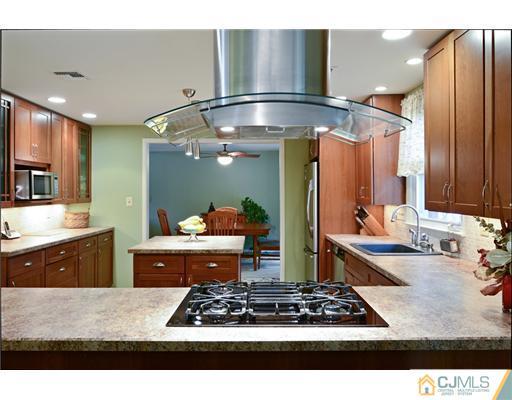 10 Midland Road Edison, NJ 08820 - Photo 8 of 18 a kitchen with stainless steel appliances granite countertop a stove a sink and a refrigerator
