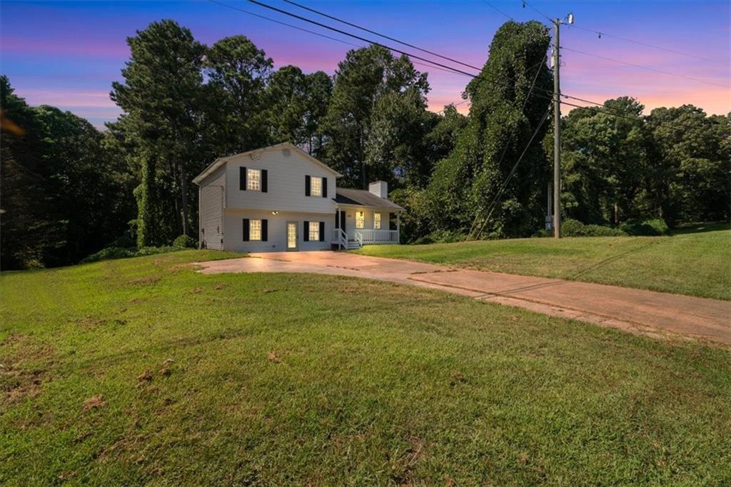 a house view with a big yard