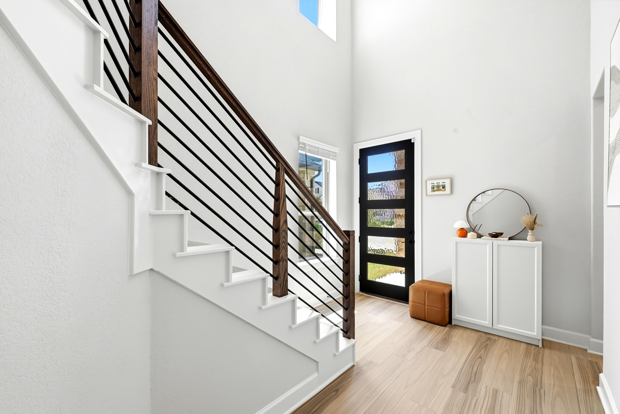 2702 Sebring Circle Austin, TX 78747 - Photo 17 of 35 A soaring entryway welcomes arrivals with light-toned flooring and a contemporary staircase.