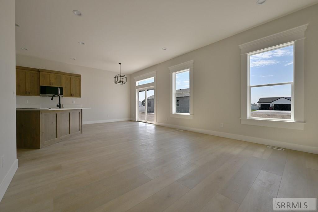 499 Fieldstone Avenue Rigby, ID 83442 - Photo 2 of 14 Great Room to Kitchen/Dining Area