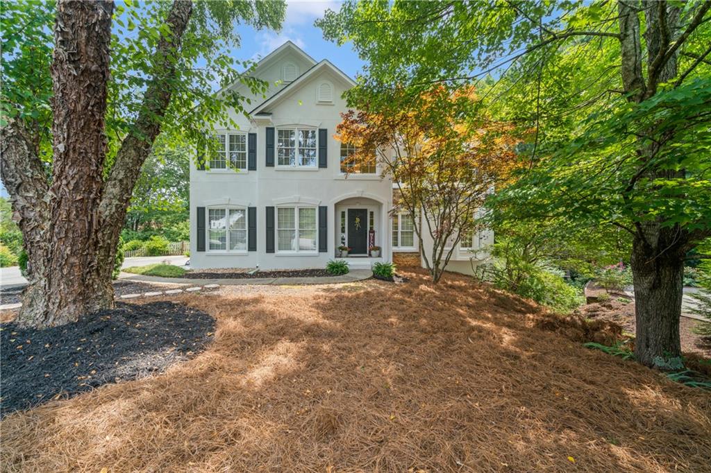 2535 Green Meadow Way Cumming, GA 30041 - Photo 1 of 1 a front view of a house with a garden