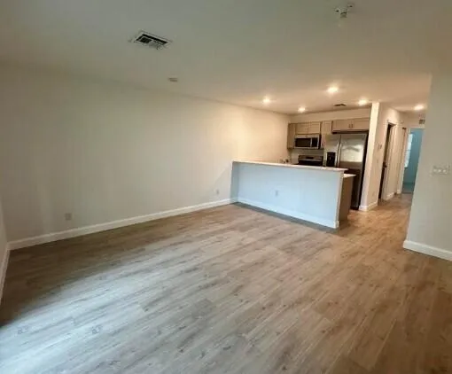 a view of a kitchen with a sink and a refrigerator