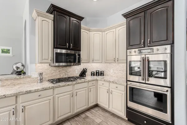a view of a dining room with furniture wooden floor and a chandelier