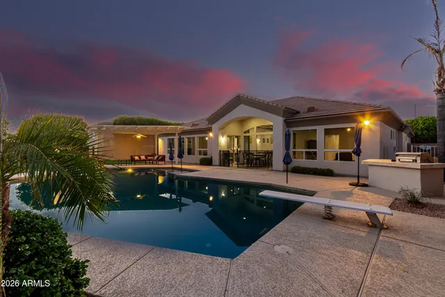 a front view of a house with a yard and trees