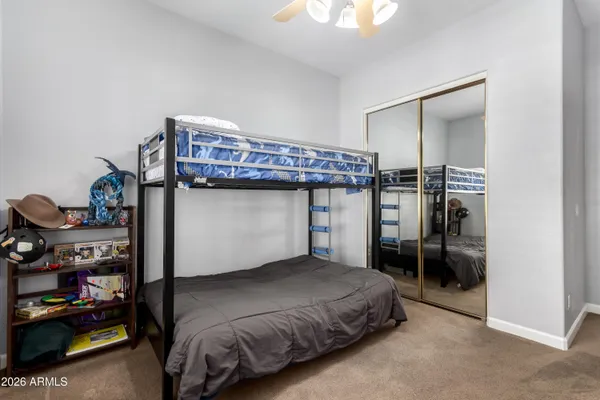 a bed sitting in a bedroom next to a window