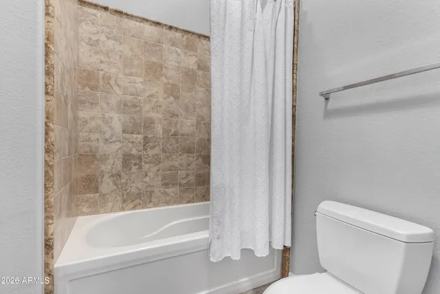 a view of a patio with table and chairs potted plants with wooden floor and fence